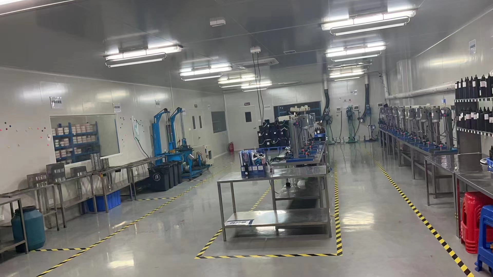 GZ New Nail production area showing processing equipment, worktables and material containers.